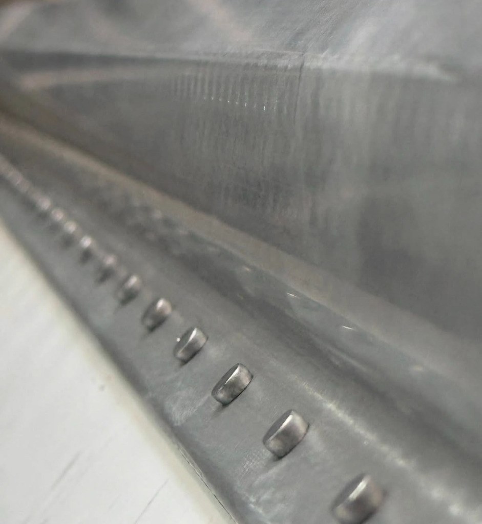 Close-up of trailer wall and post rivet work