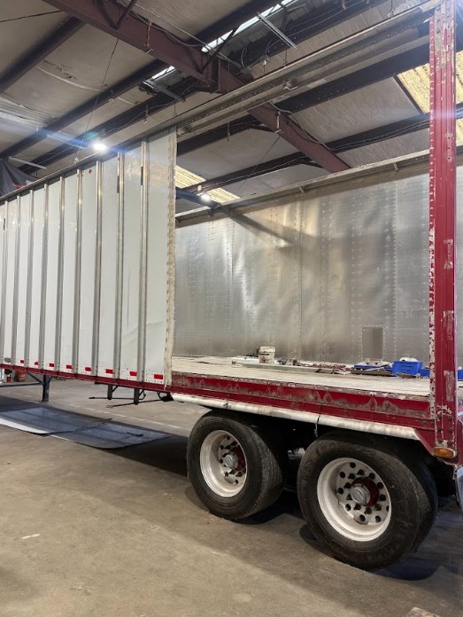 Trailer in the shop with sidewall panels removed for reconstruction